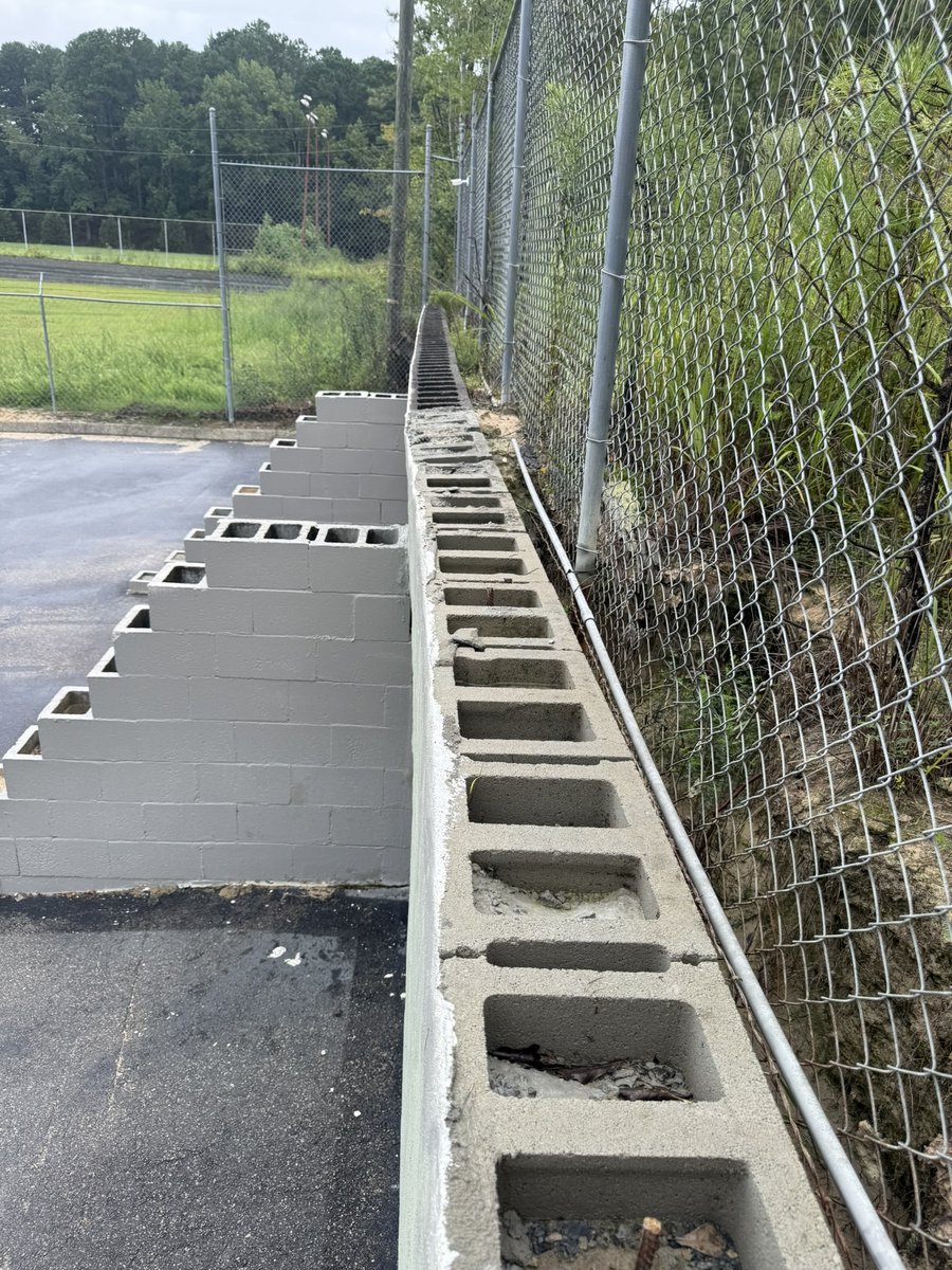 Complete grading and retaining wall project with asphalt pad